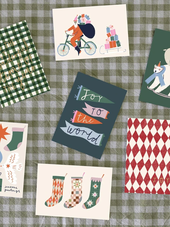 Festive Santa with Gifts Greetings Card, in a checkered table cloth. 