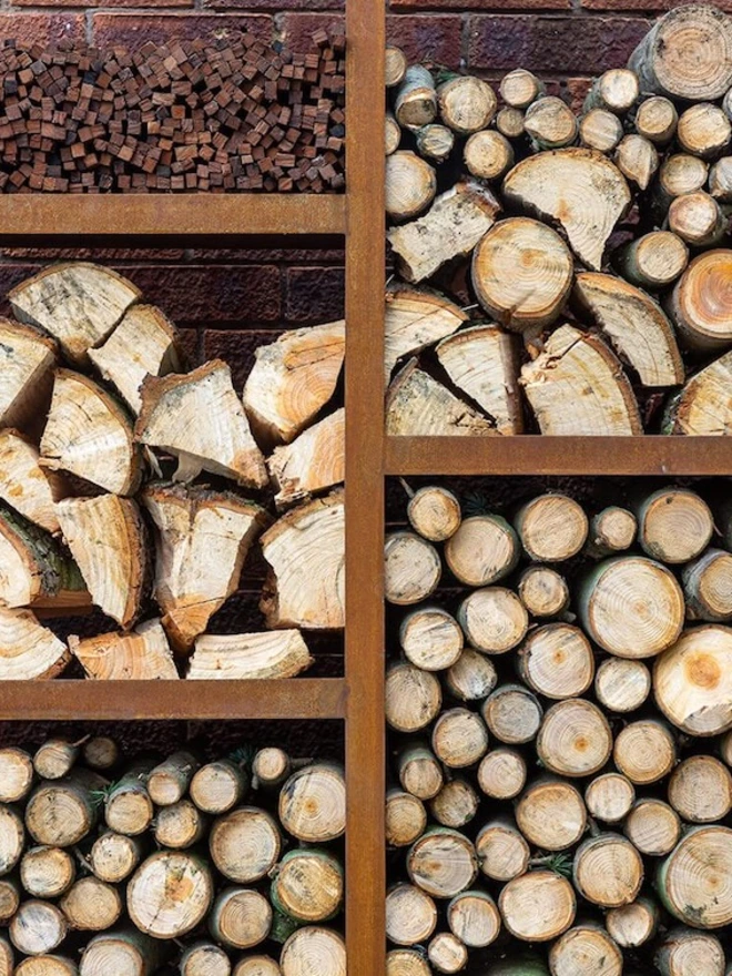 Oakham Log Store, log store filled with wood stacked in garden. 