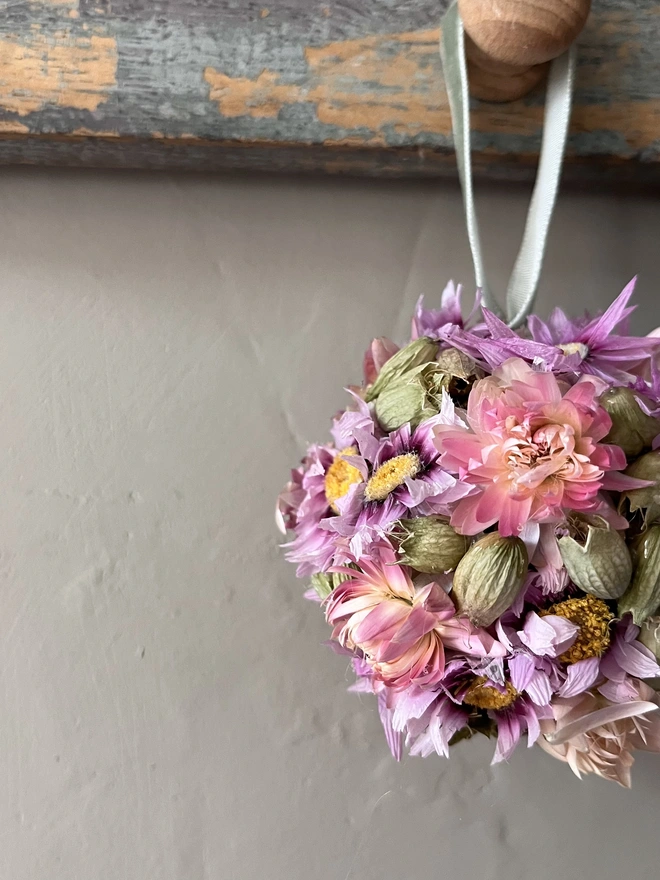Pink and Green Dried Flower Bauble. A bauble made of dried seasonal flowers.