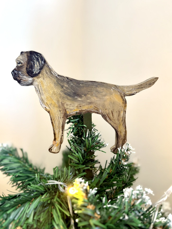 Border Terrier Dog Christmas Tree Topper Handpainted placed on the top of a Christmas Tree 