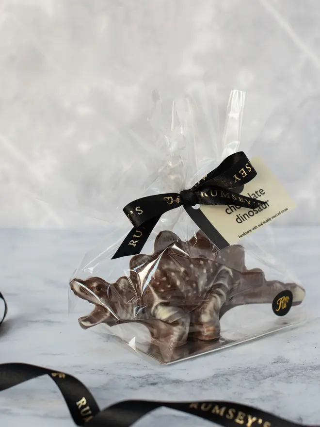chocolate dinosaur. a marbled chocolate stegosaurus in plastic packaging.