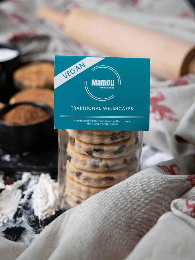 Packaged Vegan Traditional Welshcakes on a messy kitchen counter