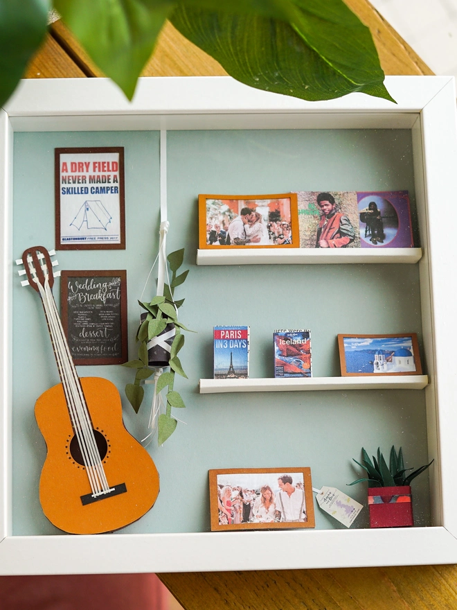 a wooden box with miniatures of the person favourite things inside. Each piece is handmade specially on request. bespoke art piece made by My Papercut Forest