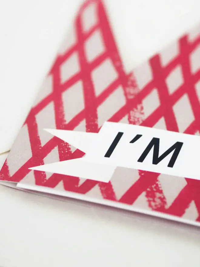 red and white grid card in crown shape with 'im the best' text