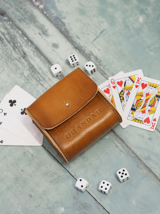 Personalised Leather Playing card and dice carry case. A hand dyed tan brown leather pouch holding two decks of cards and 6 dice. Personalised with the name GRANDAD.