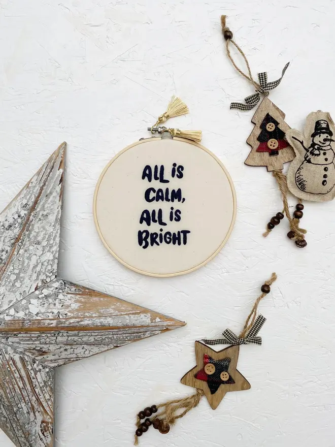 custom phrase embroidered christmas hoop. cotton hoop embroidered with assorted festive phrases.