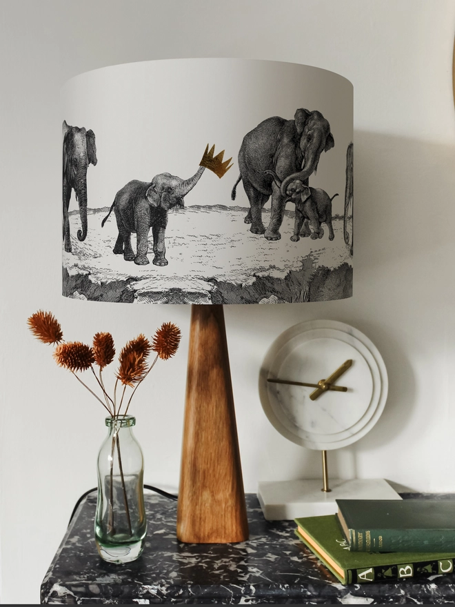 Handmade lampshade featuring adorable mischievous baby elephants playing together, inspired by Whipsnade Zoo, with a playful animal design.