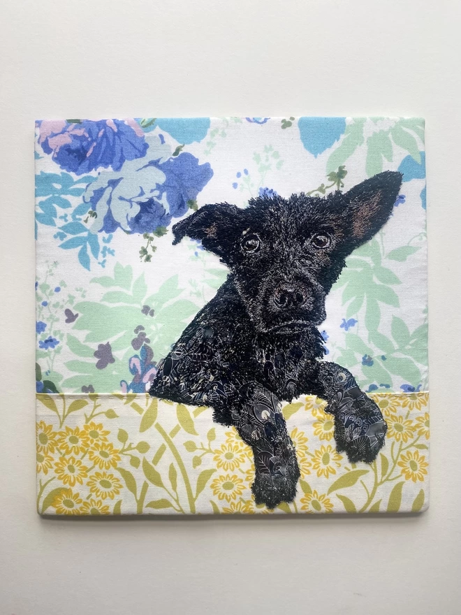 embroidered pet portrait of a black dog hanging over a bath edge