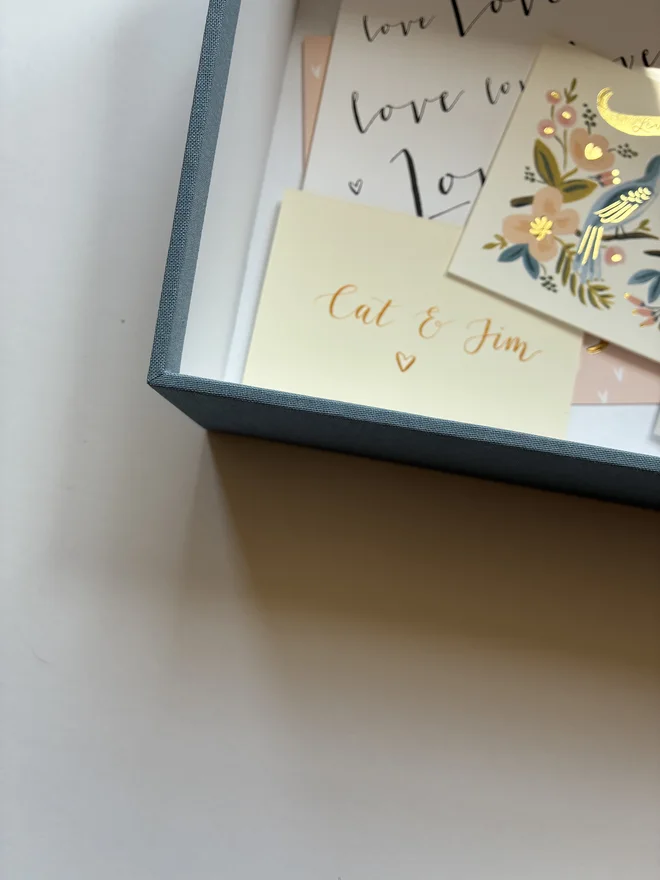 Detail of an open handmade wedding postbox with contents