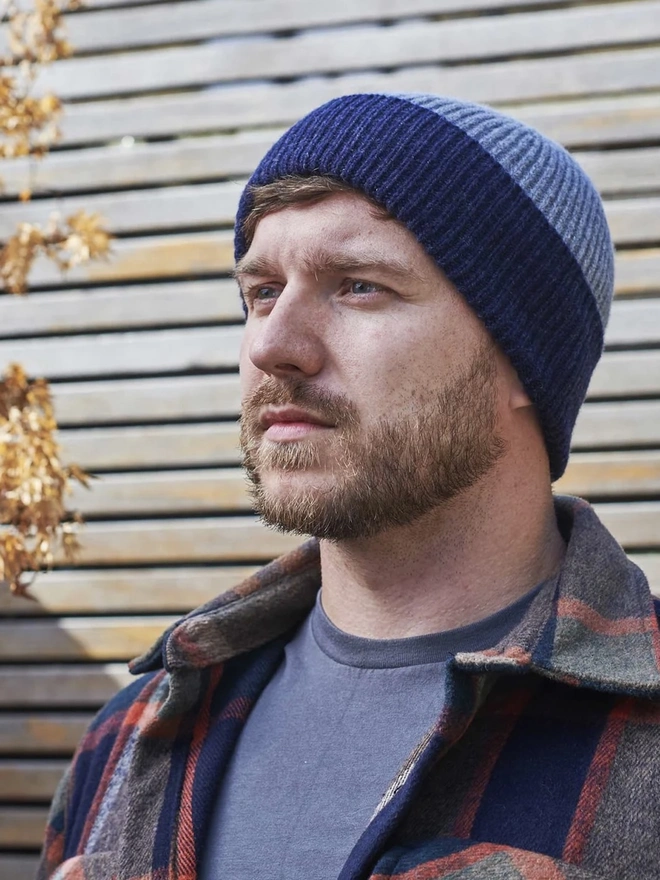 Ribbed Lambswool Men's Beanie, a person wearing a colourful ribbed beanie outdoors. 