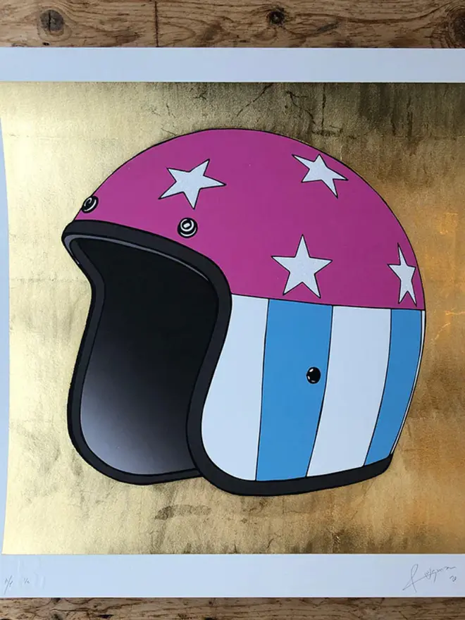 Motor cycle helmet with a star-and-stripe design on a gold background. 