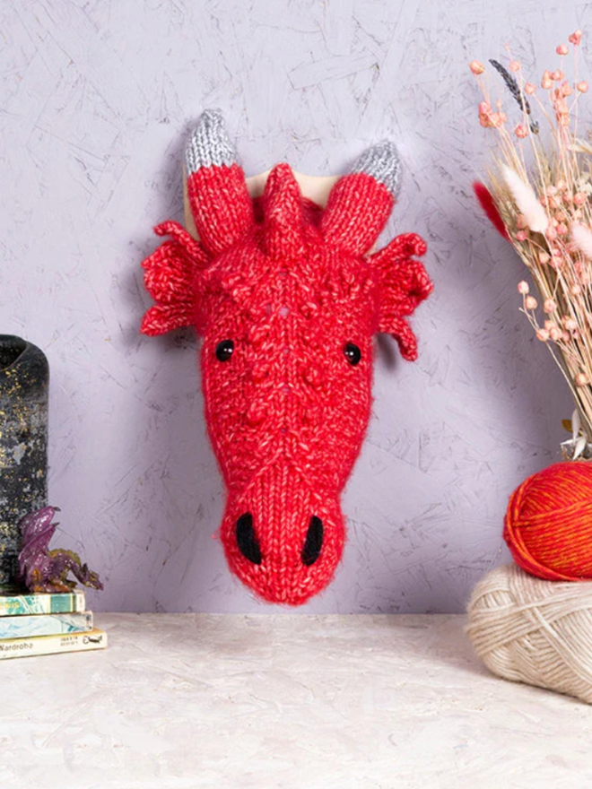 Dragon Head Knit Kit. A mini red dragon head.