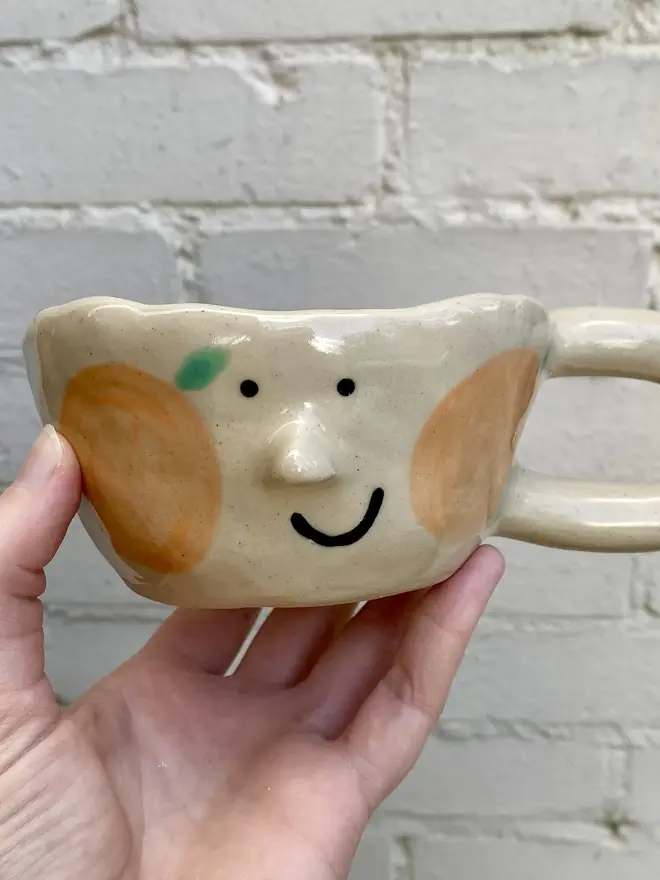 orange clementine handmade ceramic smiley face mug