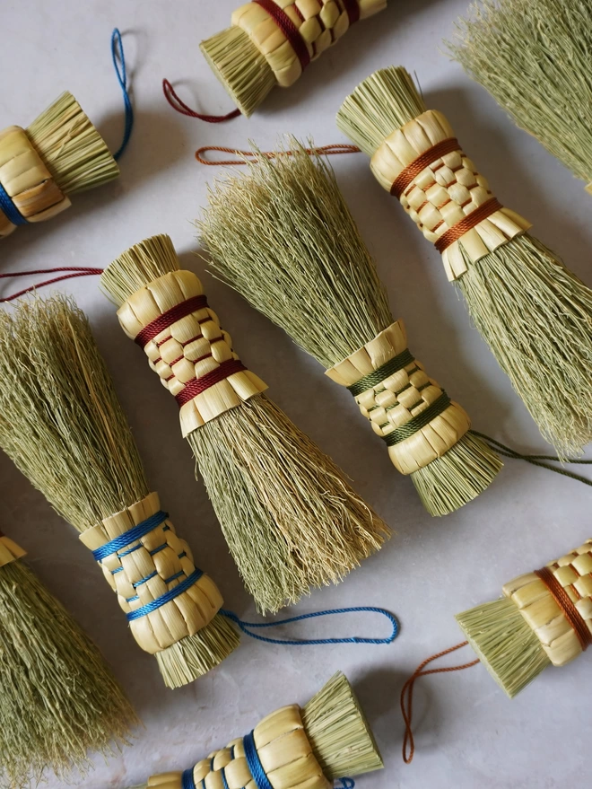 Handmade broomcorn mushroom brushes in a variety of colours