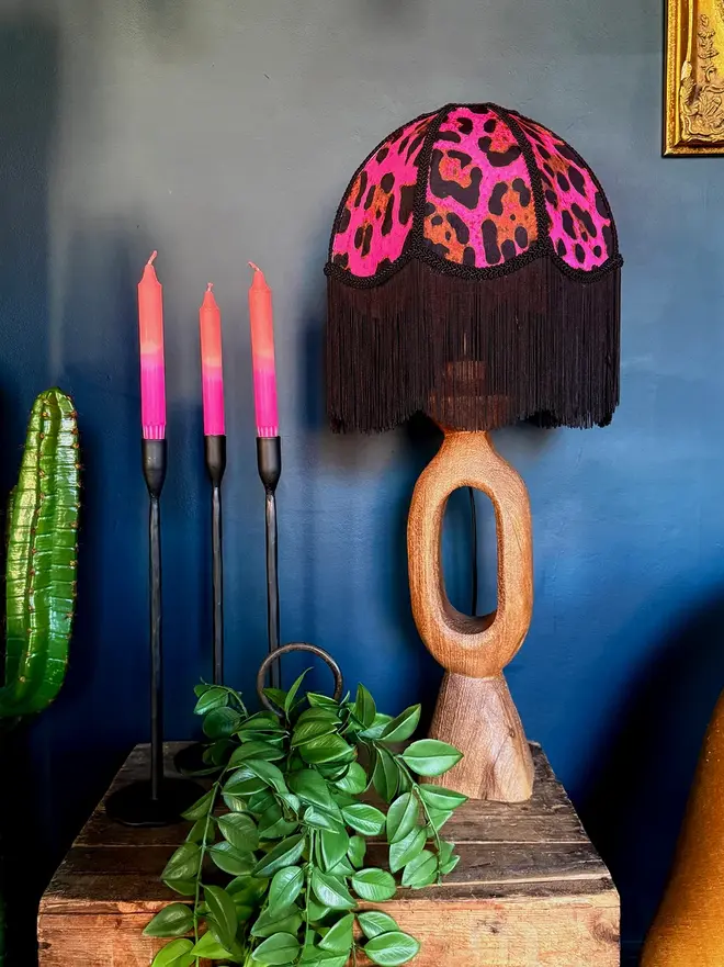 Vintage Fringed Dome Lampshade In Neon Leopard, in a room. 