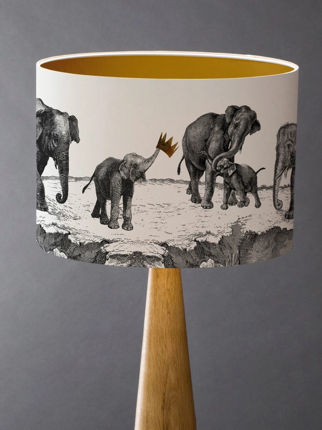 Handmade lampshade featuring adorable mischievous baby elephants playing together, inspired by Whipsnade Zoo, with a playful animal design.