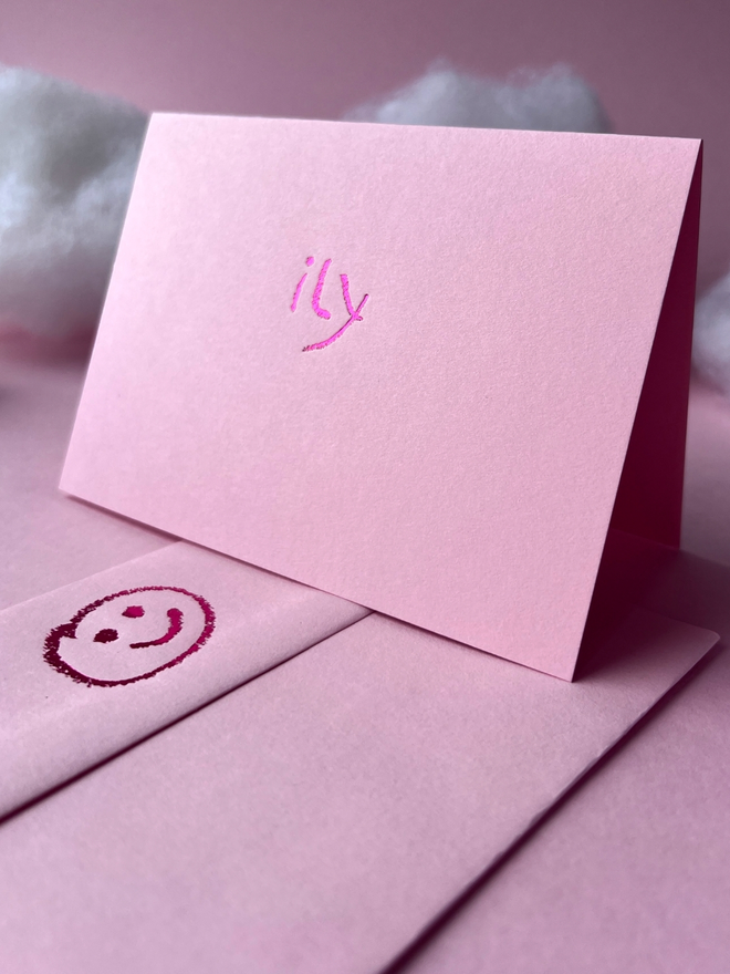pastel pink coloured card with ily  short for 'I love you' hand foiled in kids hand writing