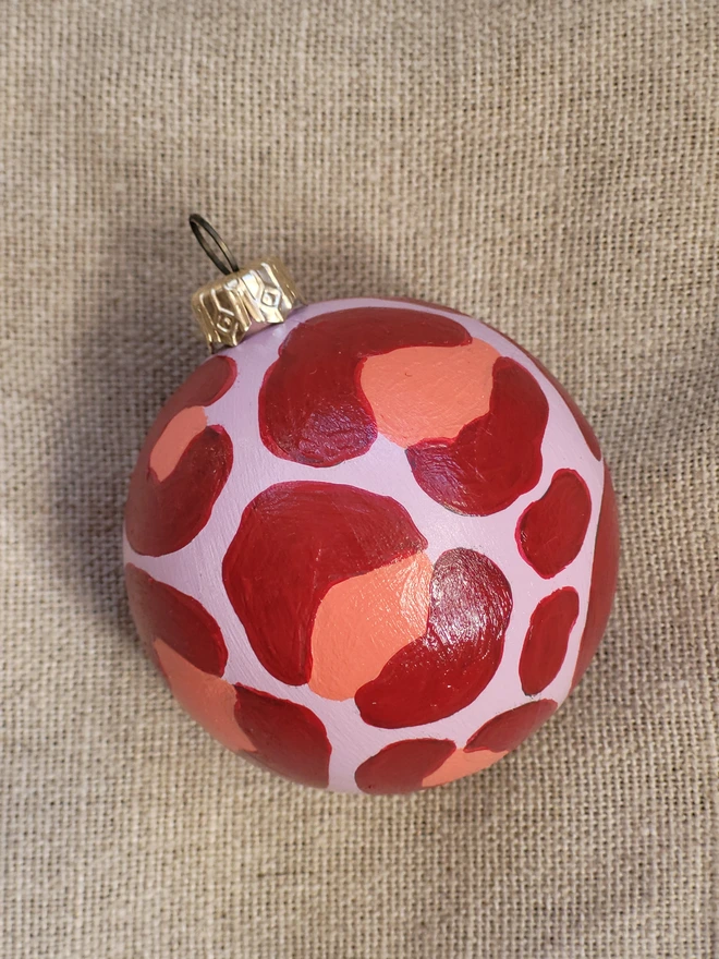 Pale pink bauble with red leopard print