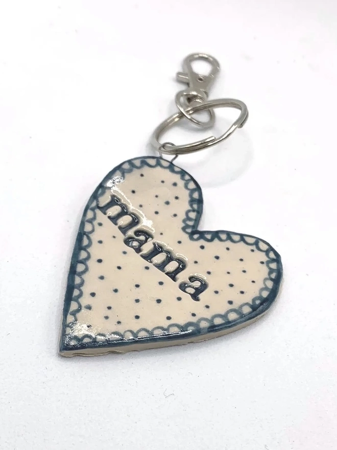 Mama Heart Ceramic Keyring, a blue keyring sitting on a plain white surface. 
