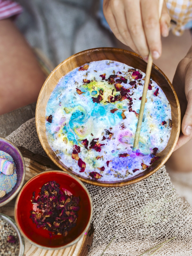 colourful potion in sction with foaming bath bombs and fizzing bath salts