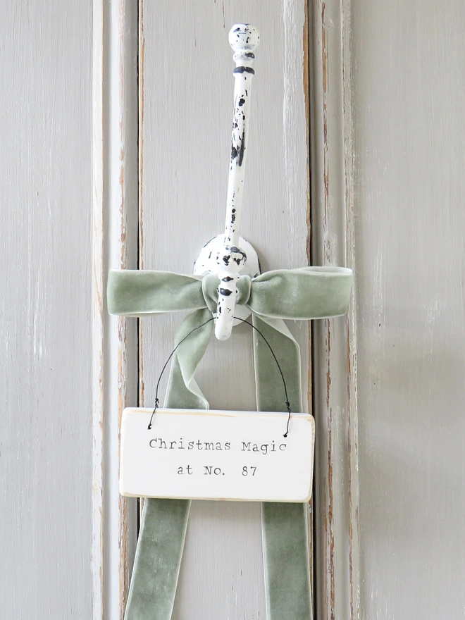 Chalky white painted wooden hanging sign with hand painted personalised Christmas Magic message