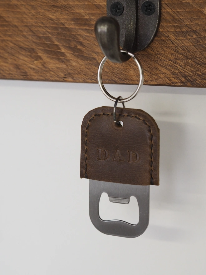 Personalised leather bottle opener key ring. Rustic brown leather key ring stamped with DAD.