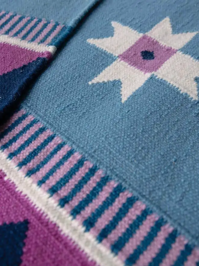 Victoria Flatweave Runner Rug, a colourful rug sitting in a decorated room.