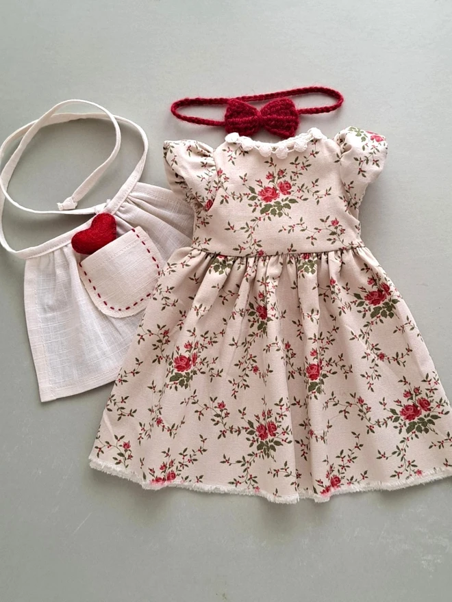 Handmade floral dress and linen apron set for Veronica Bunny, featuring a vintage rose print and red felt heart pocket