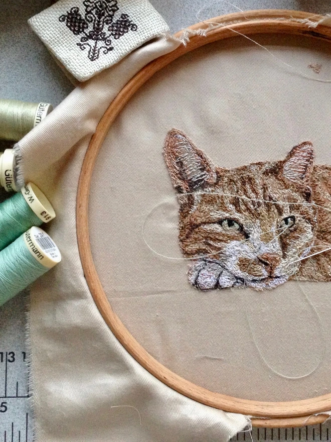 portrait shows the making of a small embroidered pet portrait