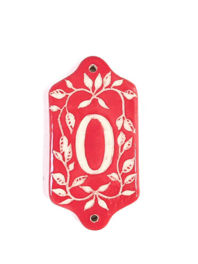 Red Sgraffito Leaf Address Tile. A tile with ‘0’.