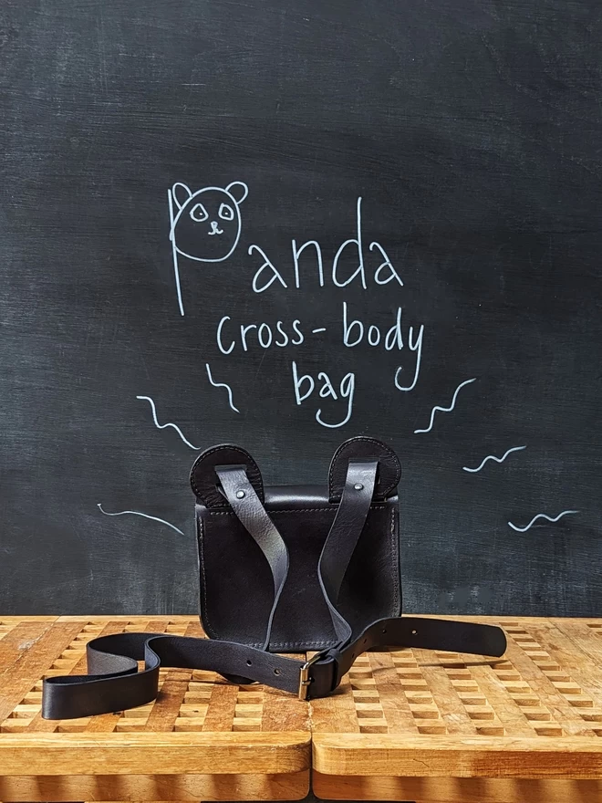 Handmade leather Panda cross- body bag, viewed from the back.