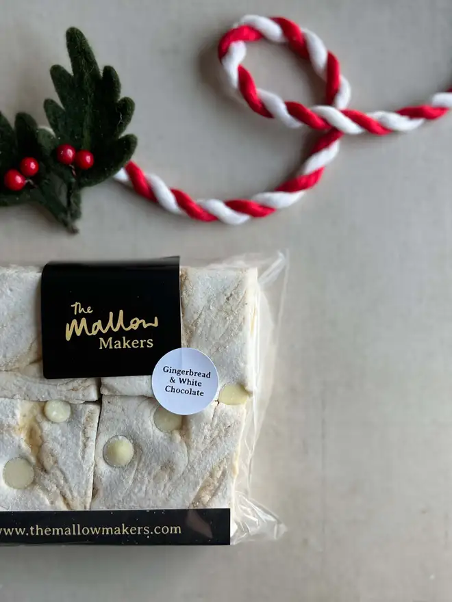 The-Mallow-makers-Looking-down-on-packet-of-four-handmade-gingerbread-and-white-chocolate-handmade-marshmallows-with-christmas-ribbon