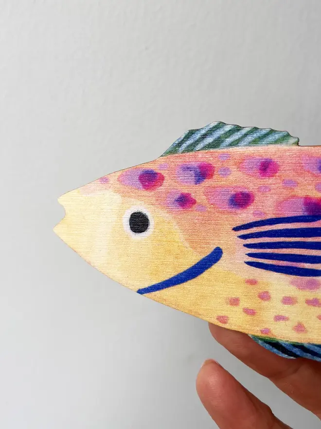 wooden fish wall decoration. close-up image of head of wooden fish wall decoration.