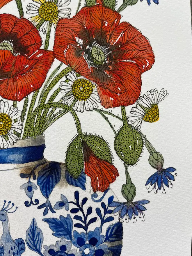 summer meadow flowers, red poppies, cornflowers and daisies in a delftware ceramic vase