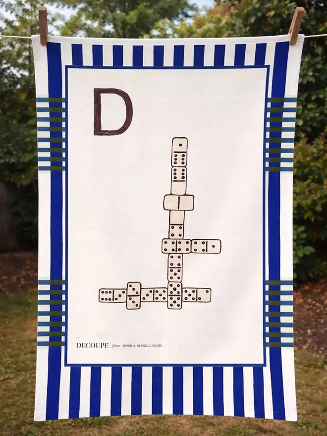 a-z alphabet tea towel. a tea towel with a domino print and the letter 'd' in the corner.