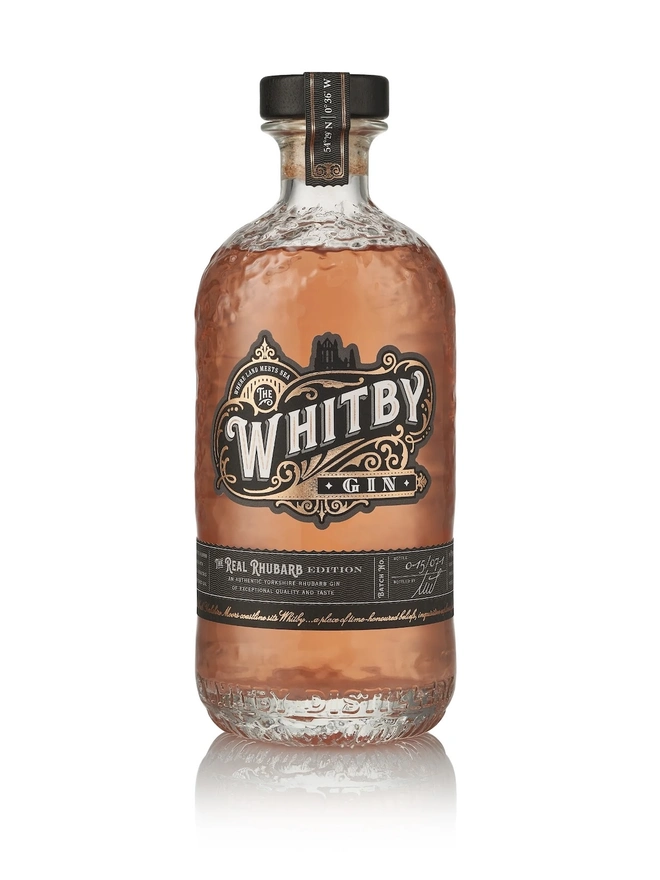 Real Rhubarb Gin, a bottle of gin sitting on a plain white surface. 