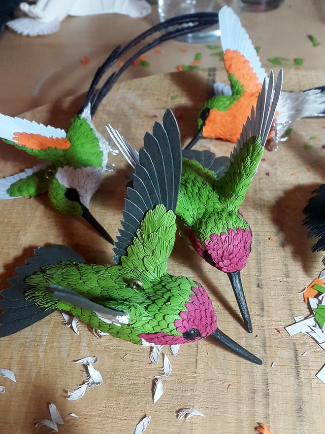 Paper hummingbirds being made in art studio