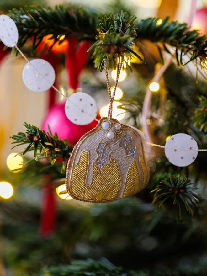 embroidered linen plum pudding decoration. embroidered beaded christmas pudding decoration hung on christmas tree.
