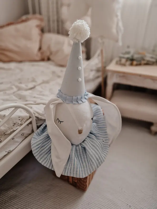 Rabbit Head Wall Mount, a cotton rabbit head wall decoration in a child's bedroom accompanied by other bedroom accessories. 