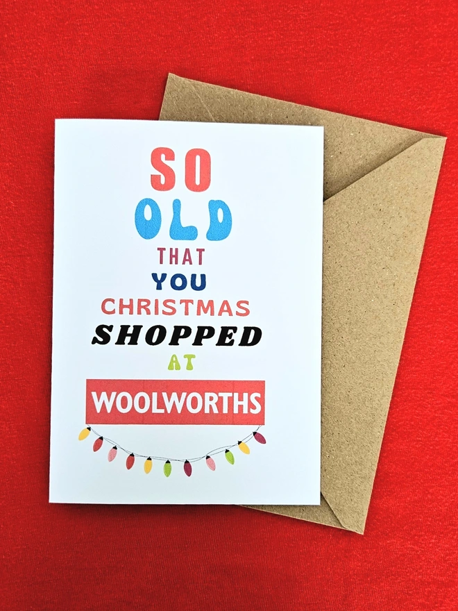 A photograph of the front of a humorous A6 greeting card illustrated using brightly coloured text and the retro shop logo. The text says so old you  Christmas shopped at Woolworths with a brown envelope.
