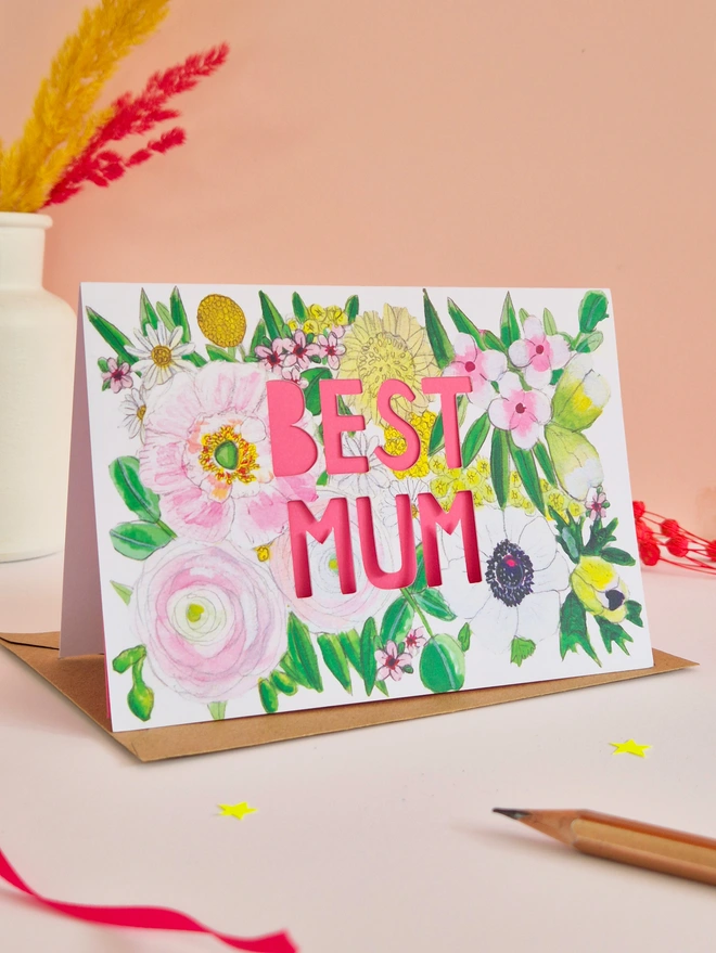 Best Mum Card with paper cut text, bright pink backing paper and a gorgeous floral illustration