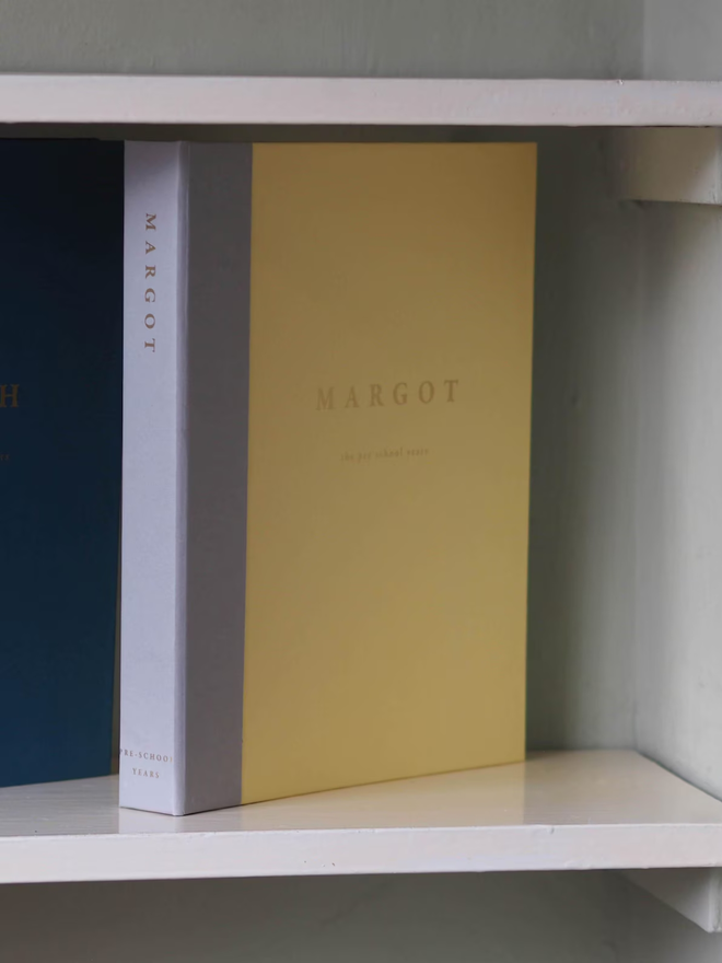 personalised keepsake ring binder. a personalised yellow ring binder on a shelf.