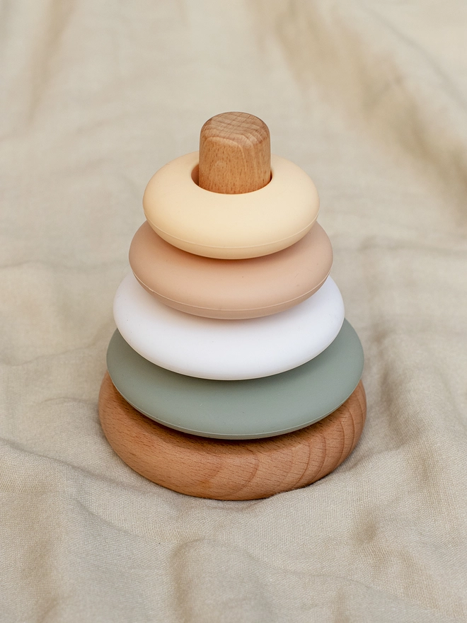 Ring stacking toy in sand, fawn, white and sage colours.