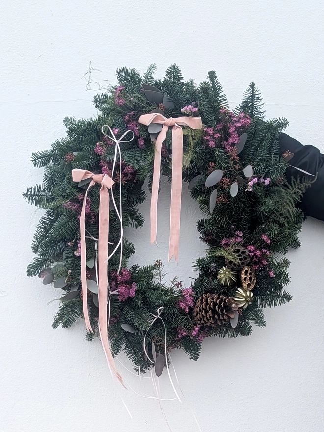 Large 20-inch handmade Christmas wreath on a wire frame, decorated with natural moss and foliage, ready for festive home décor. white background