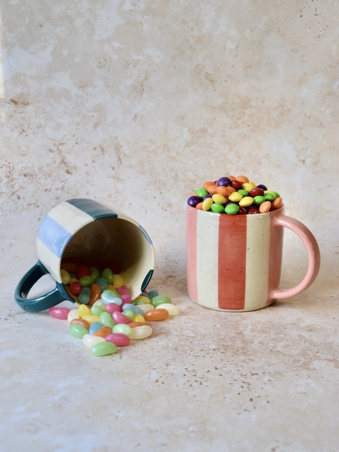 Bonbon Mug — handmade ceramic striped mug in red and pink, filled with colourful sweets