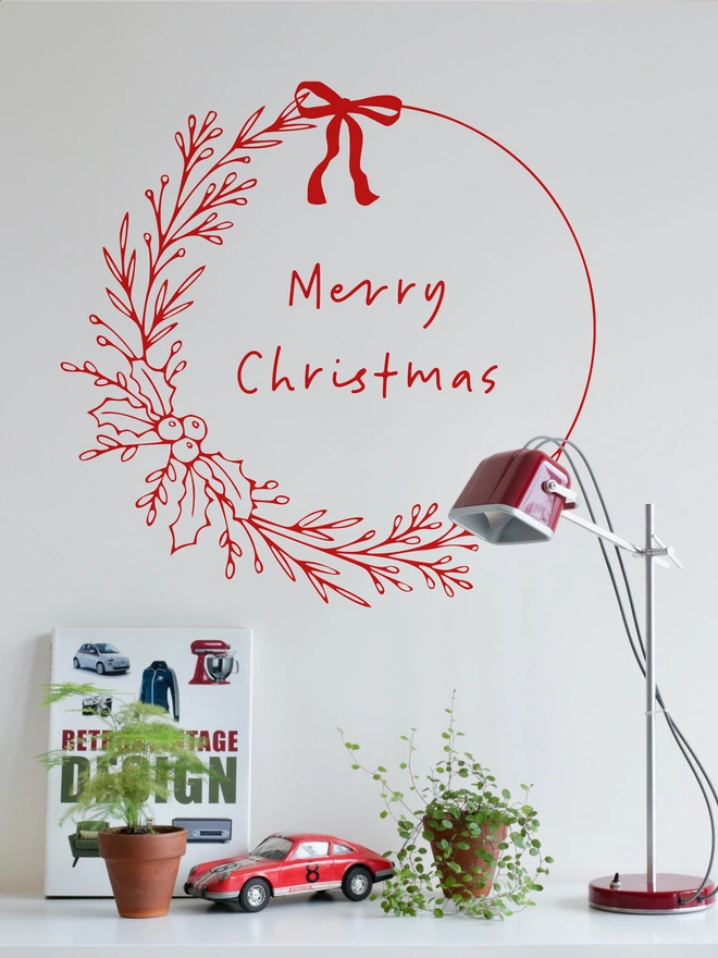 personalised floral wreath wall sticker in red on a wall