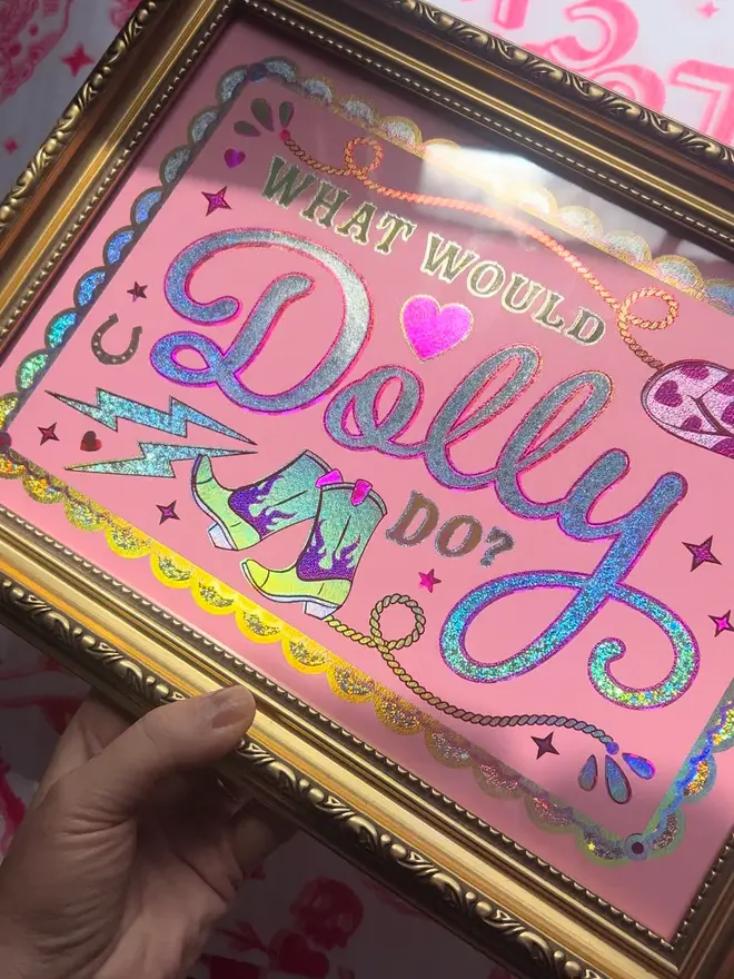 'What Would Dolly Do?' ScreenPrint, a colourful screenprint that says 'what would Dolly do?' sitting on a decorated surface. 