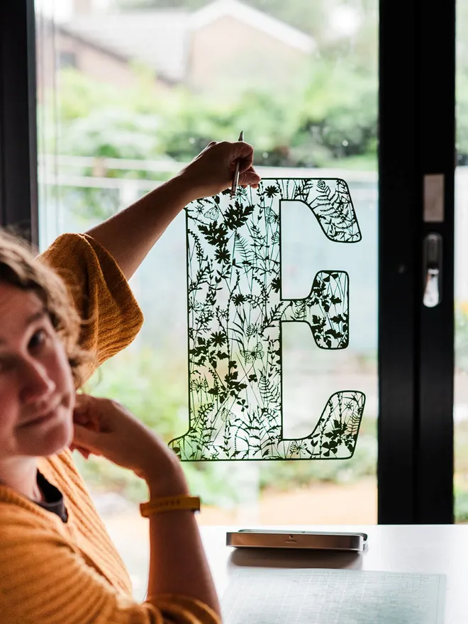 Rosie holding letter E summer theme personalised botanical initial papercut