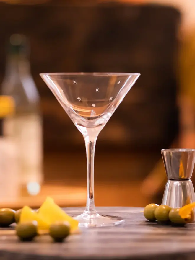 engraved stars crystal martini glass (set of 2). a martini glass patterned with small stars.