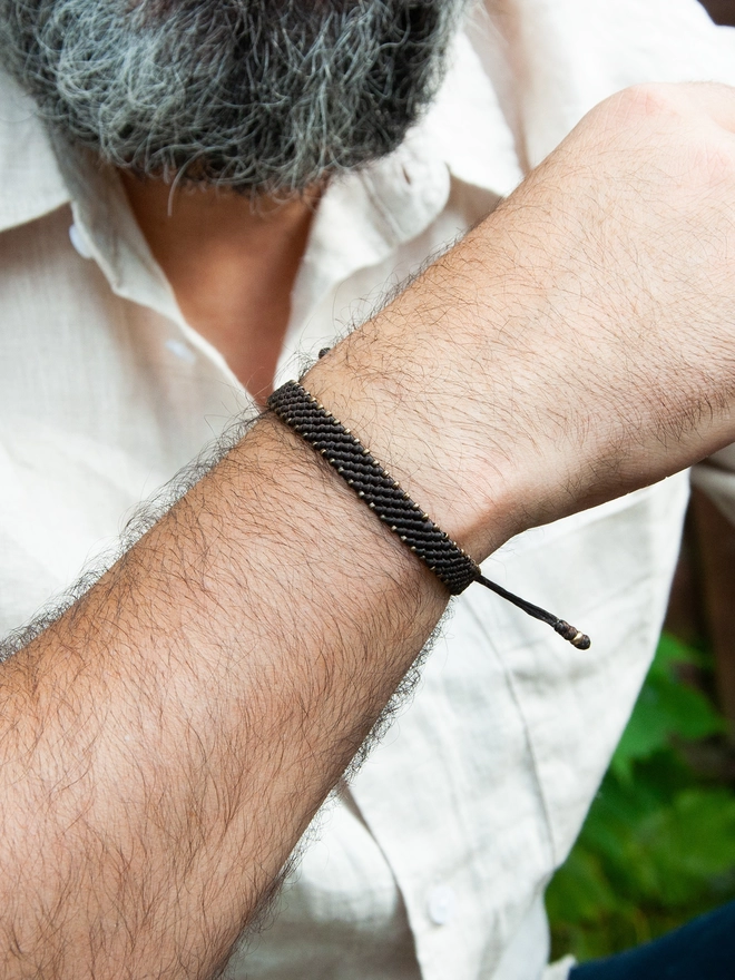 men wearing a bronze bracelet